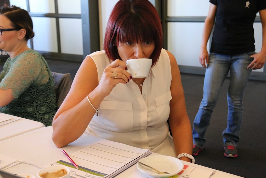 A woman drinking coffee at the 2017 Australian International Coffee Awards