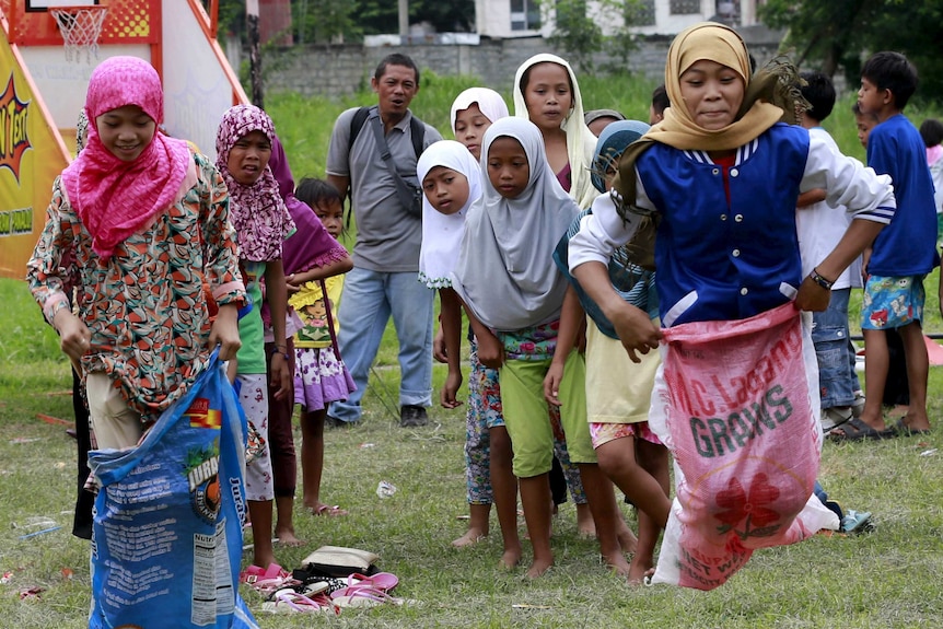 Muslim children play sack race during Eid-al-Fitr celebrations