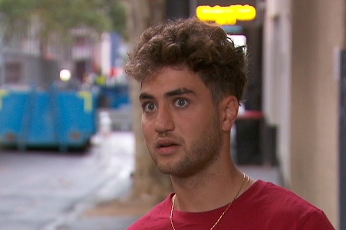 A young man with curly brown hair.