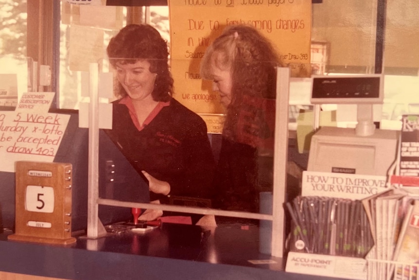 Two shop assistants behind the counter from 1980s.