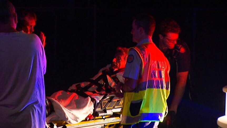 Arthur James Robert Jackson is taken by paramedics on a stretcher after escaping his burning home at Salisbury.