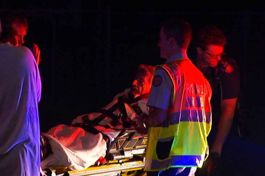 Arthur James Robert Jackson is taken by paramedics on a stretcher after escaping his burning home at Salisbury.