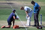 Will Pucovski hunched over after being struck by a ball during a Sheffield Shield match.