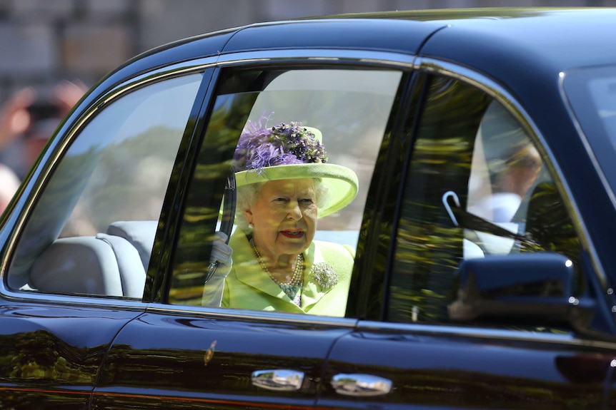 Queen Elizabeth II arrives at the wedding in her Rolls Royce.
