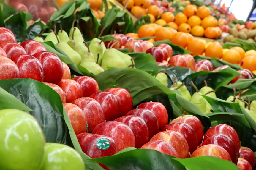 A close-up view of apples in a fresh produce section.