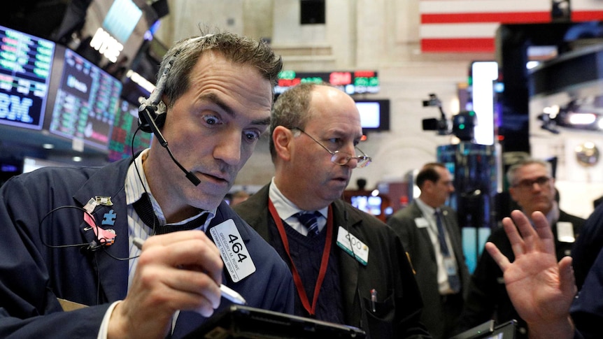 Traders work on the floor of the New York Stock Exchange (NYSE) in New York.