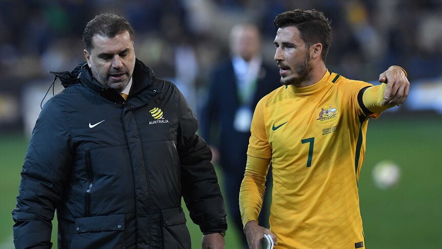 Socceroos coach Ange Postecoglou (left) and Matthew Leckie reflect on the loss to Brazil.