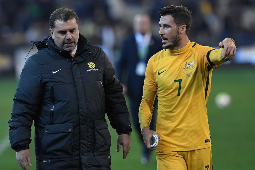 Socceroos coach Ange Postecoglou (left) and Matthew Leckie reflect on the loss to Brazil.