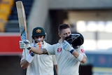 Australia's Michael Clarke (R) and Mike Hussey after Clarke's double century at the Gabba in 2012.