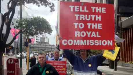 Supporters of child sex abuse victims hold placards outside royal commission in Perth.jpg