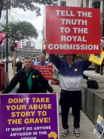 Supporters of child sex abuse victims hold placards outside royal commission in Perth.jpg