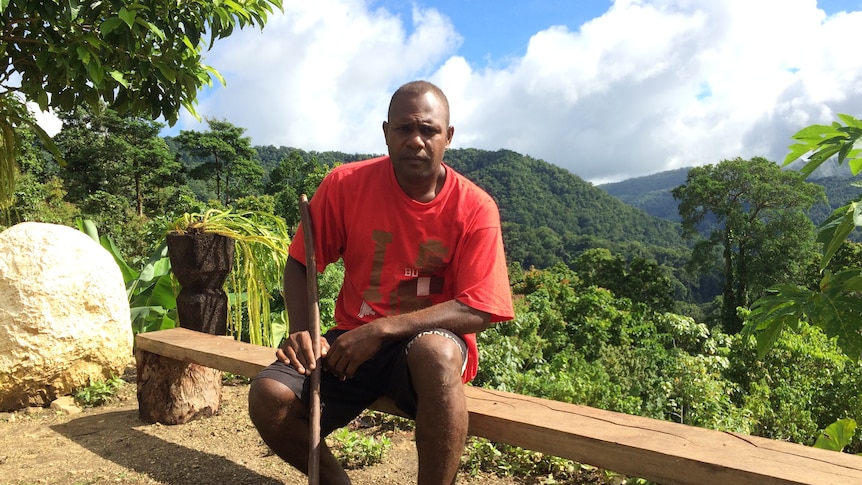 Farmer Lesley Sanga sitting on a bench in Malaita province of Solomon Islands