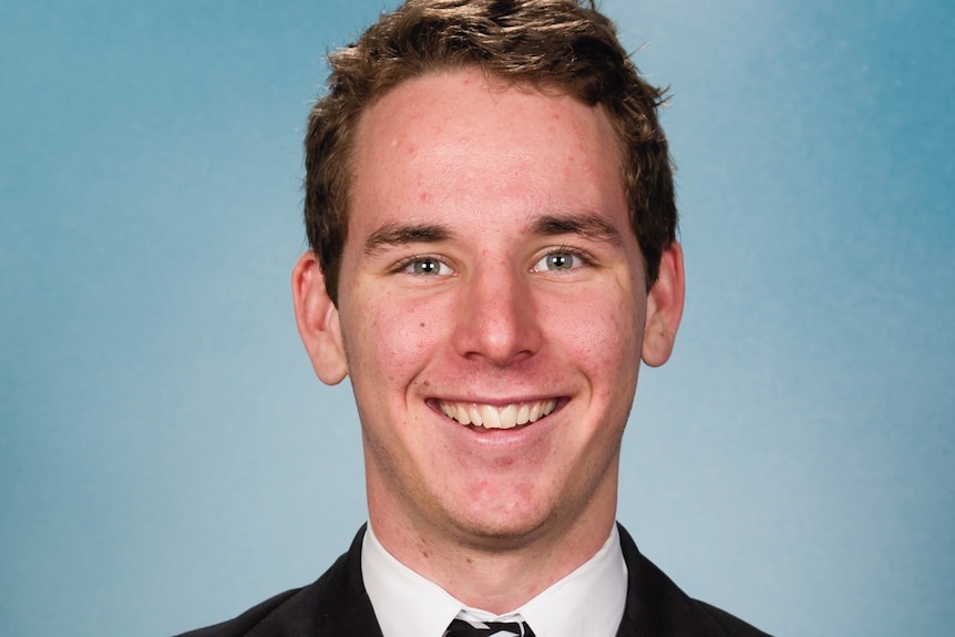 A young man smiling in a school photo