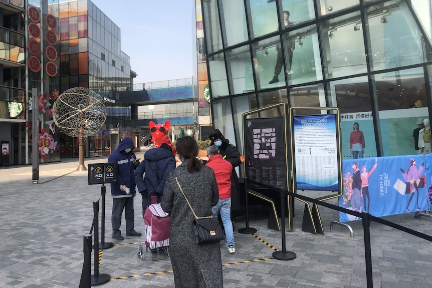 Shoppers get temperature checks as they enter the Taikoo Li shopping mall in Beijing.