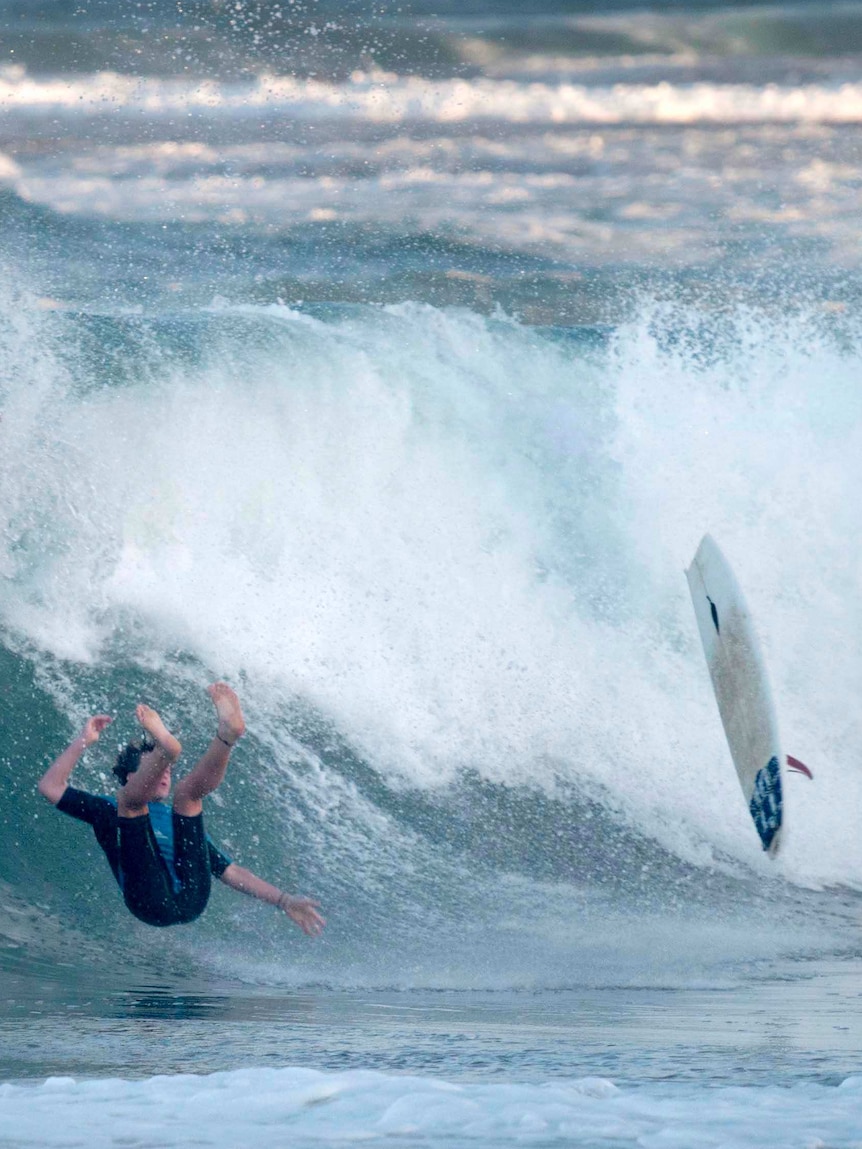 A surfer wipes out.