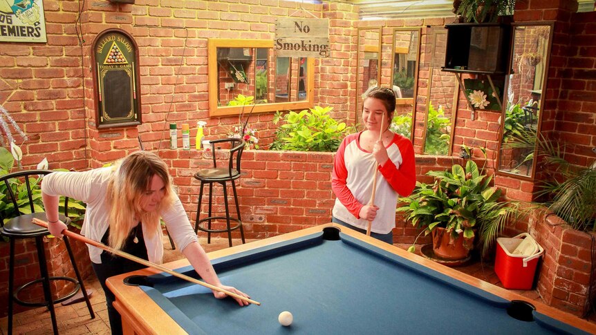 Paige and Tea Johnston playing pool at their grandparents home.