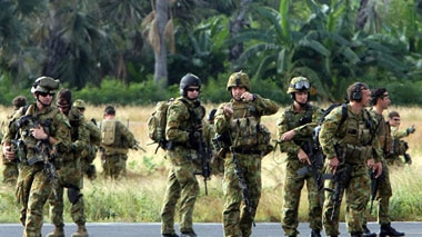 Australian soldiers take their positions after disembarking at Dili airport.