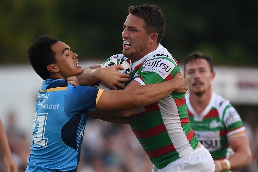Welcome back ... Sam Burgess takes on the Titans defence
