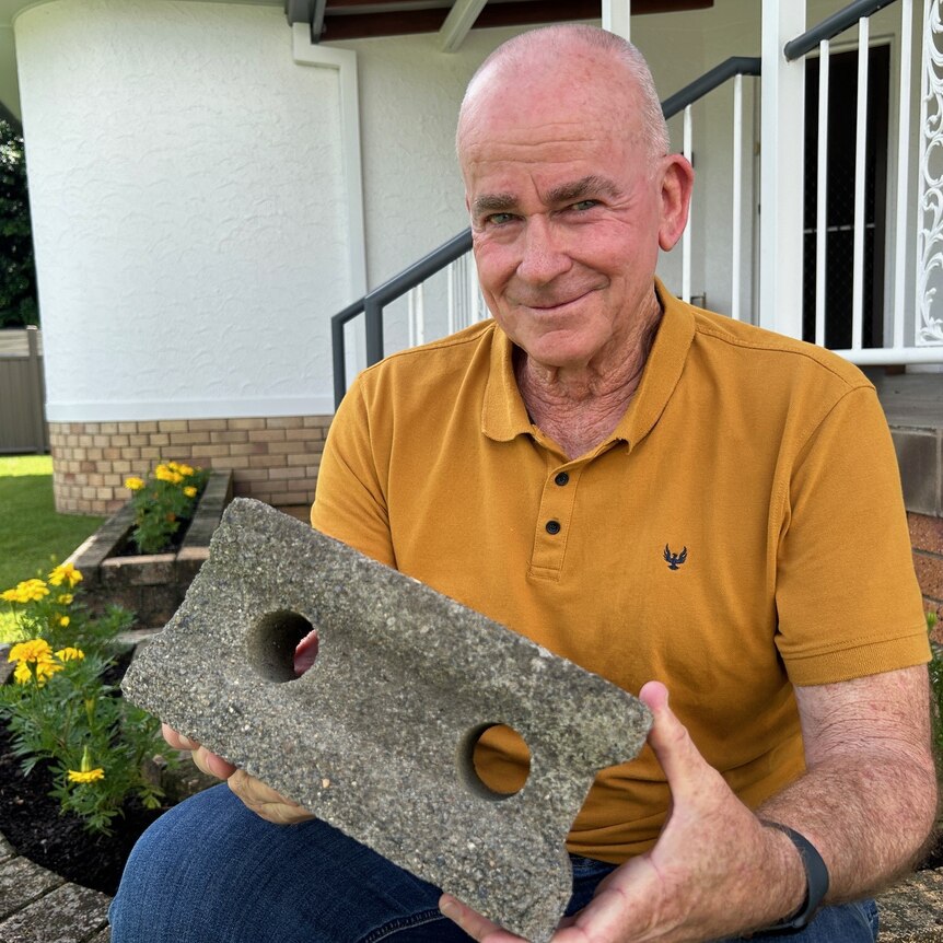 man with concrete brick