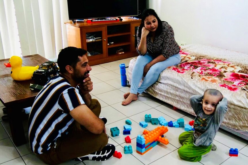Shinder Kaur and Jatinder Singh with their son Ranvir, who is surrounded by toy blocks.