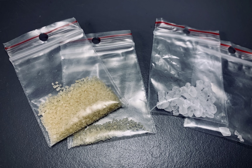 Four bags of drugs, one containing brown granules and another with white cubes