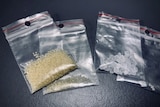 Four bags of drugs, one containing brown granules and another with white cubes