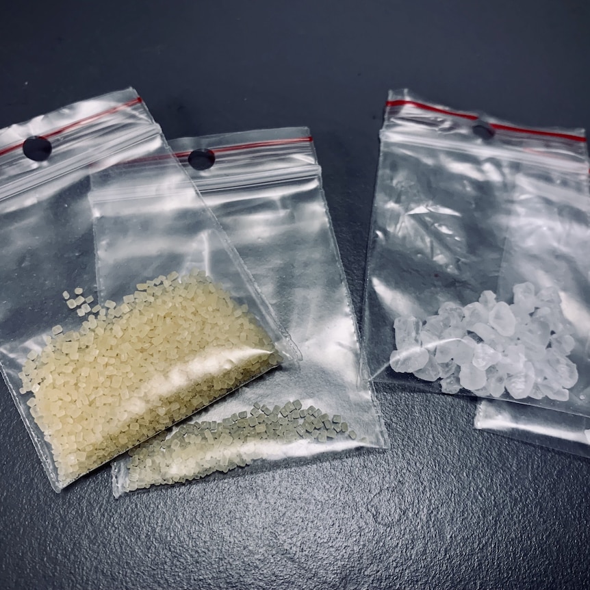 Four bags of drugs, one containing brown granules and another with white cubes