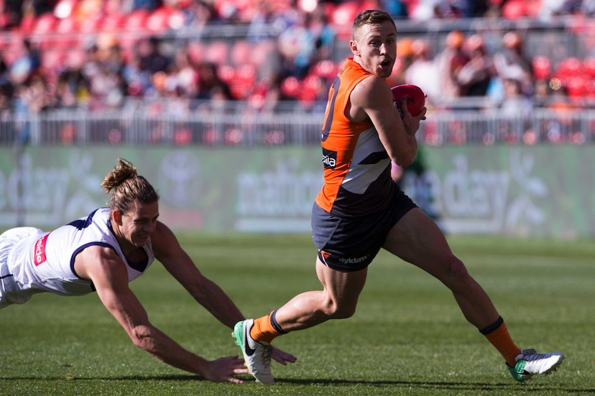 Devon Smith runs the ball for GWS