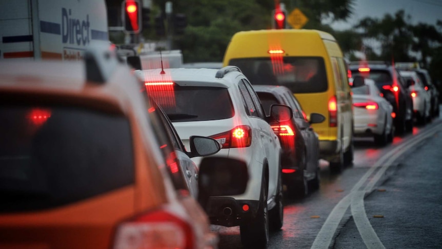 Cars lined up in the rain in traffic along Gladstone Road at Highgate Hill in Brisbane.