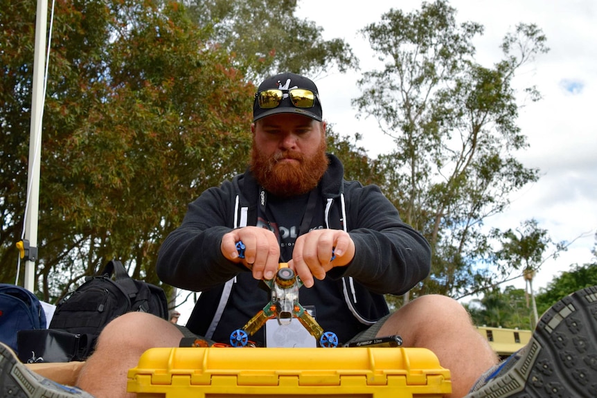 A drone racer prepares