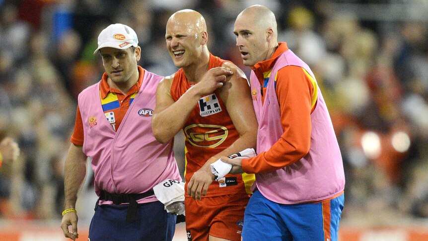Suns captain Gary Ablett comes off the field in pain against Collingwood at Carrara in July 2014.