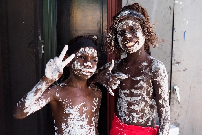 Two Aboriginal children with white paint on them
