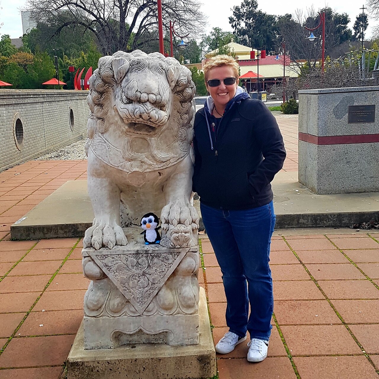 Anne-Marie McCarthy stands next to a lion sculpture