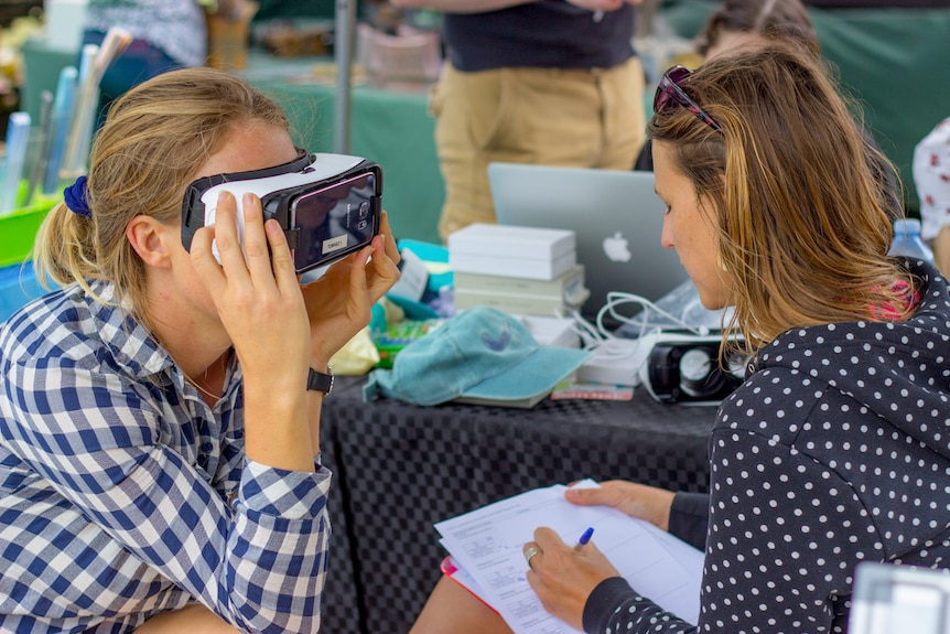 Dr Julie Vercelloni takes notes while a participant views the reef from dry land.