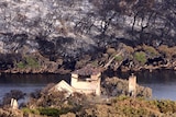 The remains of Wallcliffe House sit among the scorched earth at Prevelly Park after bushfires.