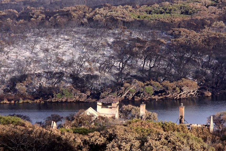 The remains of Wallcliffe House sit among the scorched earth at Prevelly Park after bushfires.