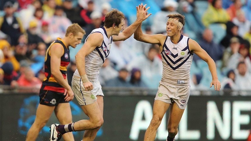 Michael Barlow (L) of the Dockers celebrates after kicking a goal against the Crows.