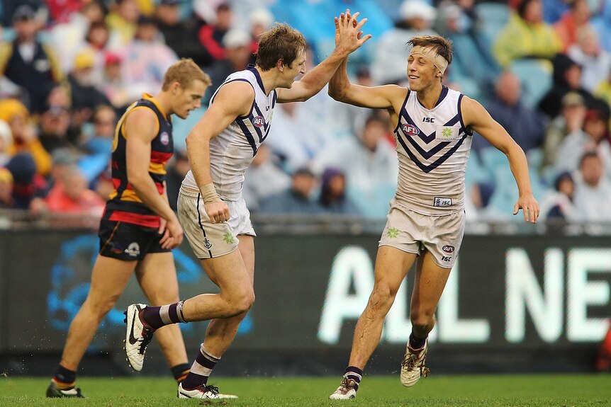 Michael Barlow (L) of the Dockers celebrates after kicking a goal against the Crows.