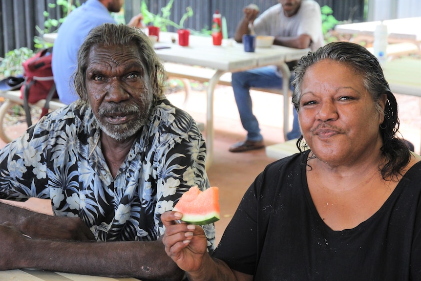Josephine Thompson is pictured with her brother eating food at Centrecare's breakfast program for homeless people in Broome. 