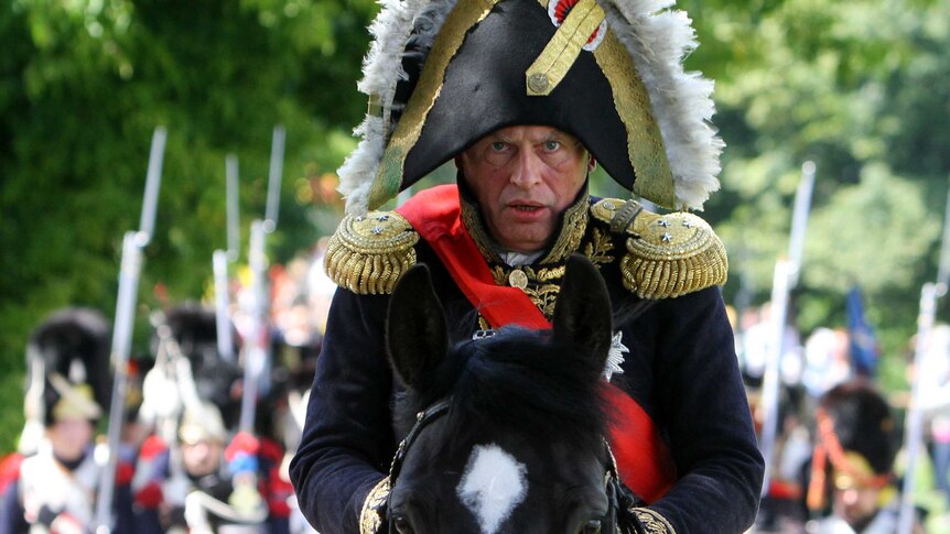Oleg Sokolov stares straight ahead as he sits on a horse wearing a Napoleon costume.