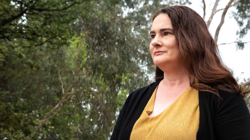 Portrait of a  middle-aged woman with long brown hair outdoors in Canberra.