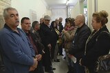 People wait to seek help with immigration applications at the Assyrian Resource Centre in Fairfield, western Sydney.