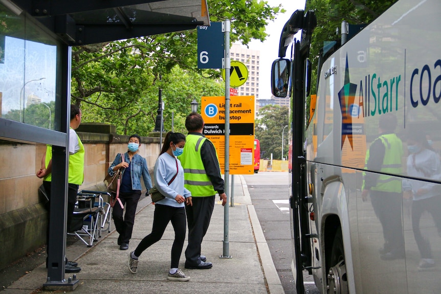 a woman stepping on a bus