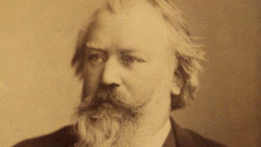 A portrait of composer Johannes Brahms from 1889 with a full beard and moustache.