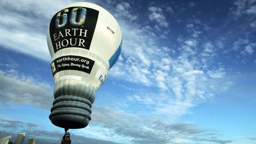 An Earth Hour light-bulb-shaped hot air balloon takes flight over Sydney Harbour