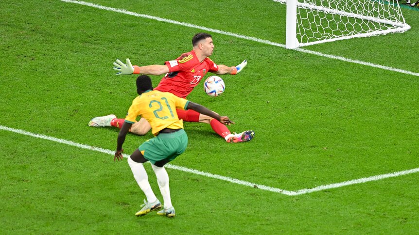 Australia's Garang Kuol stands close to goal as his shot is saved by the Argentinian goalkeeper. 