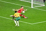 Australia's Garang Kuol stands close to goal as his shot is saved by the Argentinian goalkeeper. 