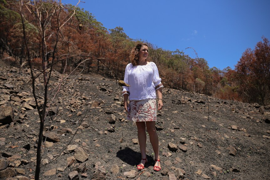 Jenny Hayes amongst burnt bushland