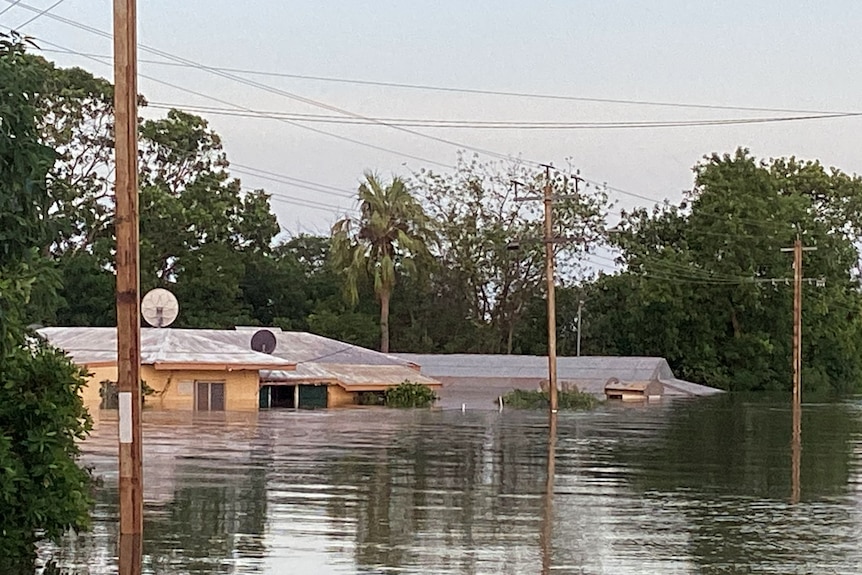A row of homes underwater in a rural street