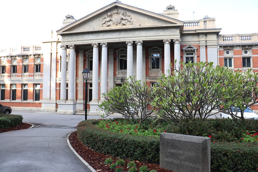 A wide shot of the front of the Supreme Court of WA with a garden bed in the foreground.